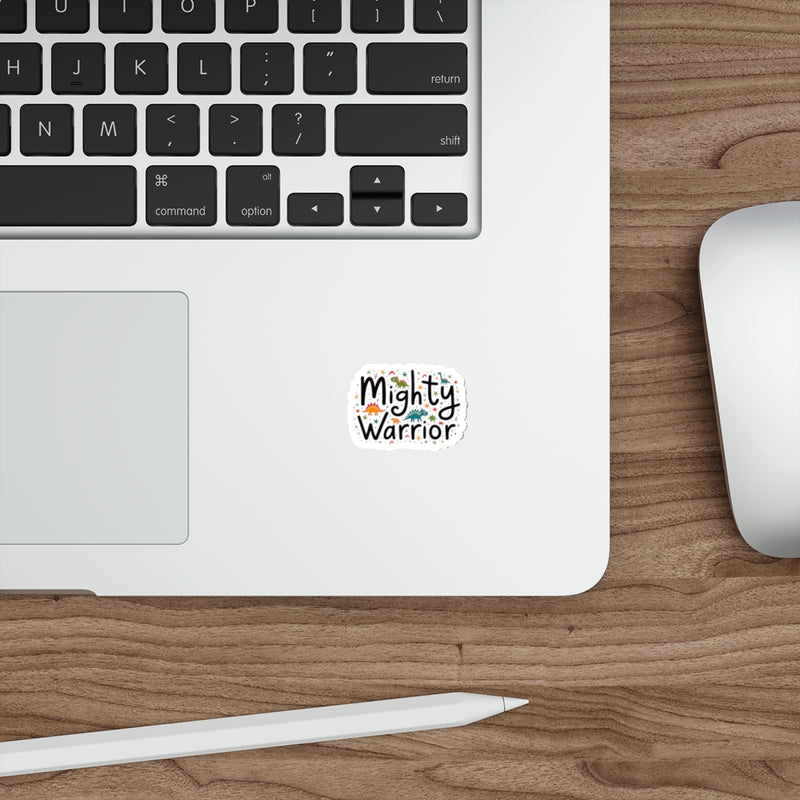Laptop with 'Mighty Warrior' sticker on a wooden desk with a mouse and stylus.