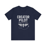 Faith-based t-shirt with “Creator Pilot” text, flight emblem with cross and wings, Christian apparel for Kingdom creators.