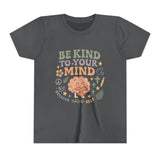 Retro-style t-shirt with “Be Kind to Your Mind” text, featuring a smiling cartoon brain hugging a heart, surrounded by peaceful doodles and affirmations like “Breathe,” “Grow,” and “Rest.”