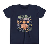 Retro-style t-shirt with “Be Kind to Your Mind” text, featuring a smiling cartoon brain hugging a heart, surrounded by peaceful doodles and affirmations like “Breathe,” “Grow,” and “Rest.”