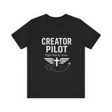 Faith-based t-shirt with “Creator Pilot” text, flight emblem with cross and wings, Christian apparel for Kingdom creators.