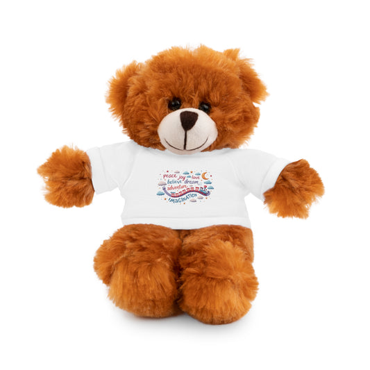 Brown plush teddy bear wearing a white shirt with a colorful design that includes the words peace, joy, love, believe, dream, adventure, and imagination, surrounded by stars, clouds, and a toy train.