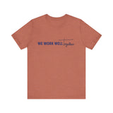 Typography shirt design reading “We Work Well Together” with a cross-inspired T, representing unity with Jesus.