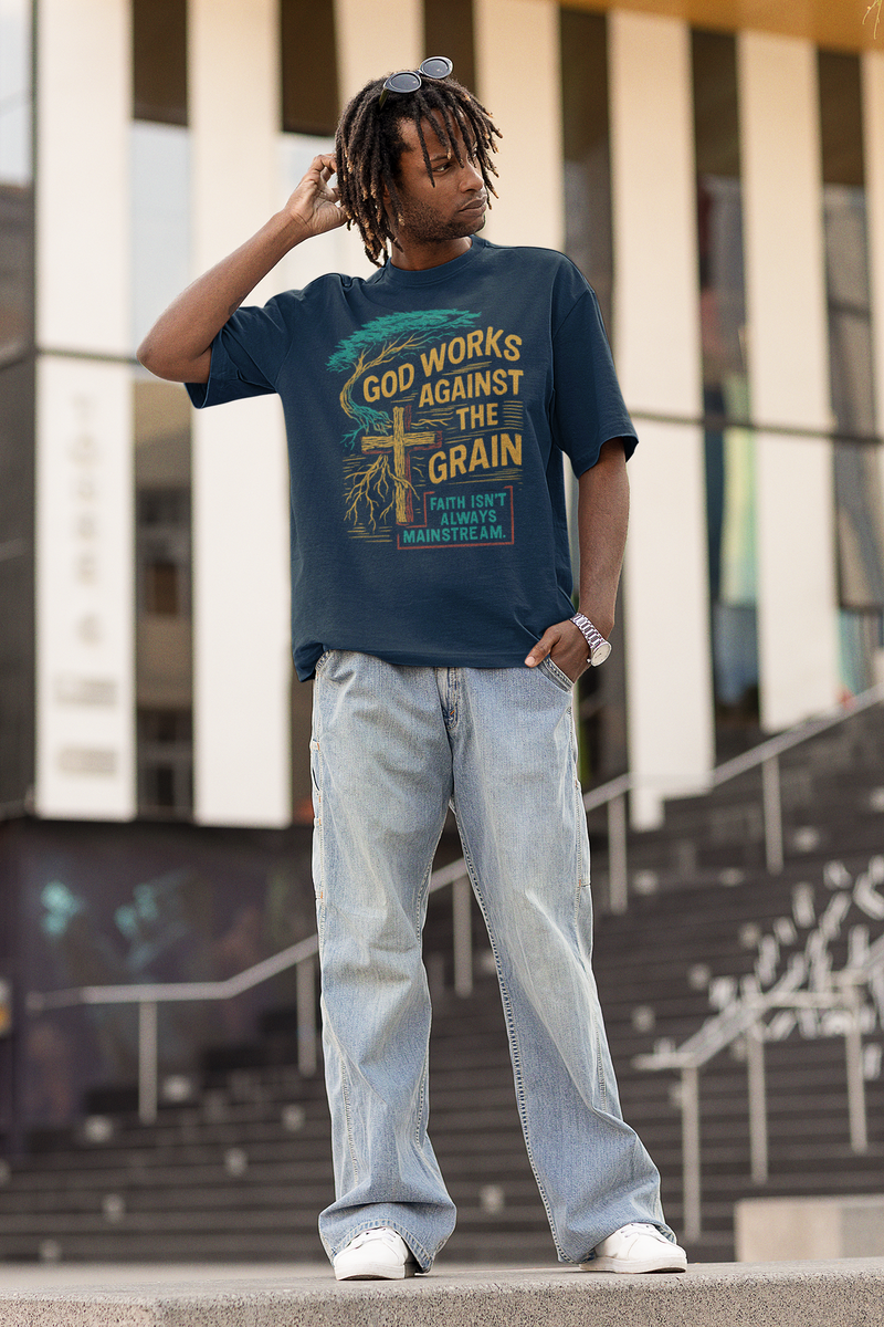 "Model wearing God Works Against the Grain Christian t-shirt in black, faith-based streetwear style by Klippette."