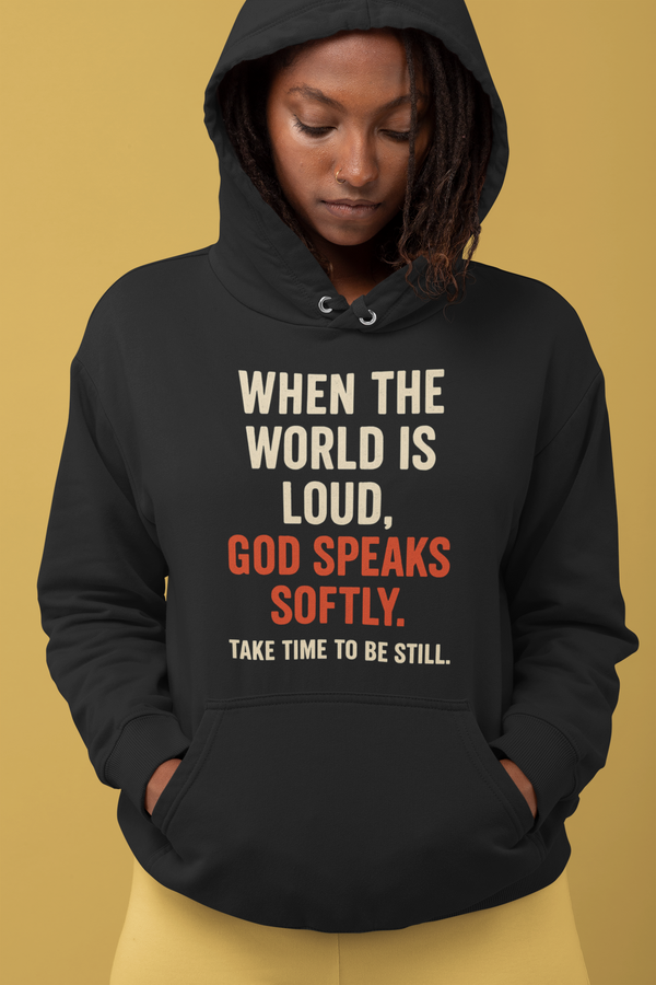 Faith-based hoodie with the quote “When the world is loud, God speaks softly. Take time to be still” 

