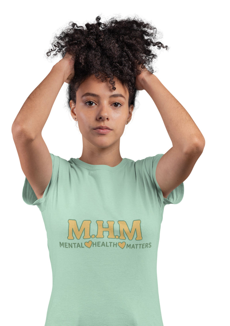 Person wearing a green t-shirt with 'M.H.M. Mental Health Matters' text on a white background