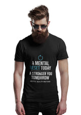 Man wearing a black t-shirt with motivational quote on a white background