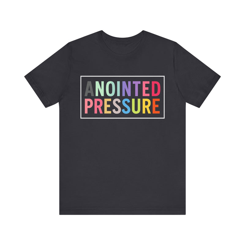 “Anointed Pressure” in bold pastel-colored letters, framed in white on a black background, representing strength and purpose through faith.

