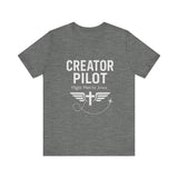 Faith-based t-shirt with “Creator Pilot” text, flight emblem with cross and wings, Christian apparel for Kingdom creators.