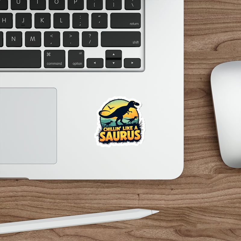 Laptop with a 'Chillin' Like a Saurus' sticker on a wooden desk