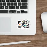 Laptop with a 'Mighty Warrior' sticker on a wooden desk