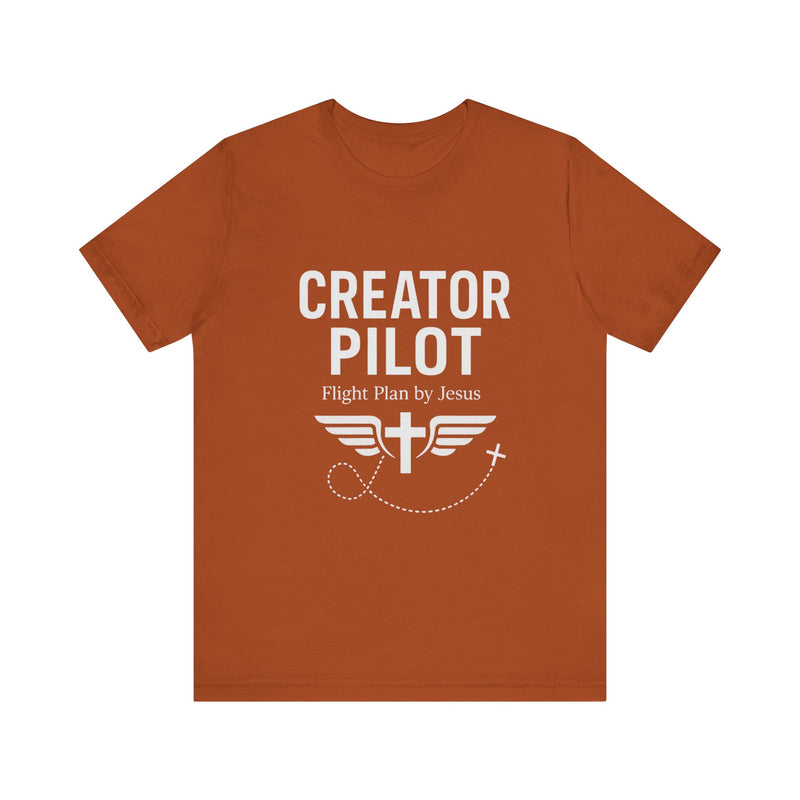 Faith-based t-shirt with “Creator Pilot” text, flight emblem with cross and wings, Christian apparel for Kingdom creators.