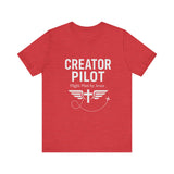 Faith-based t-shirt with “Creator Pilot” text, flight emblem with cross and wings, Christian apparel for Kingdom creators.