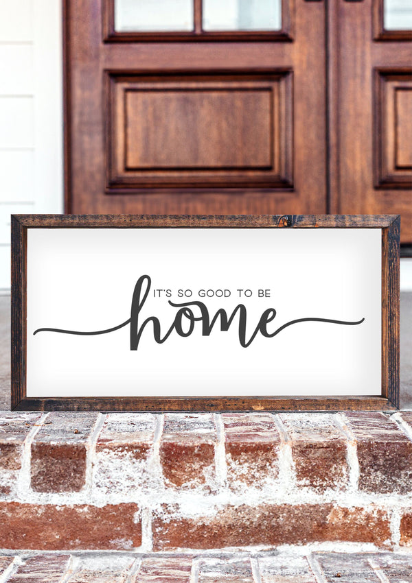 Rustic wooden sign with soft, neutral tones and the phrase “It’s So Good to Be Home” in elegant lettering, perfect for cozy home décor.