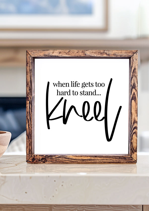 Inspirational wooden sign with the quote “When life gets too hard to stand, kneel.” Perfect for Christian home décor and prayer rooms.